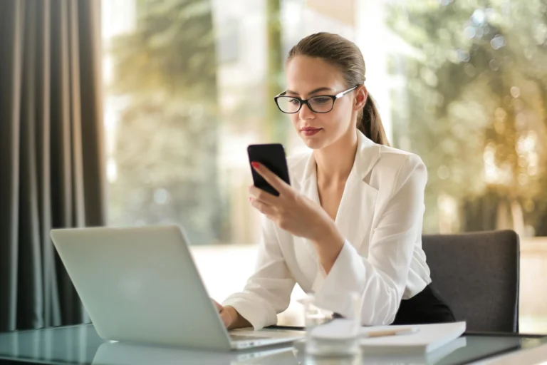 Digital distraction with phone buzzing beside person at desk