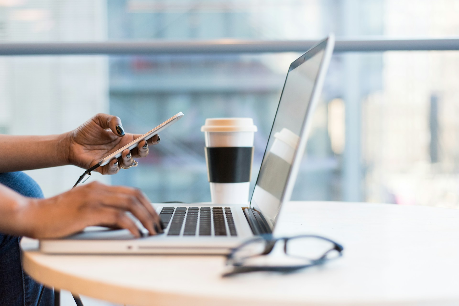 Person working on laptop at a desk — contact WordAnytime personal development blog
